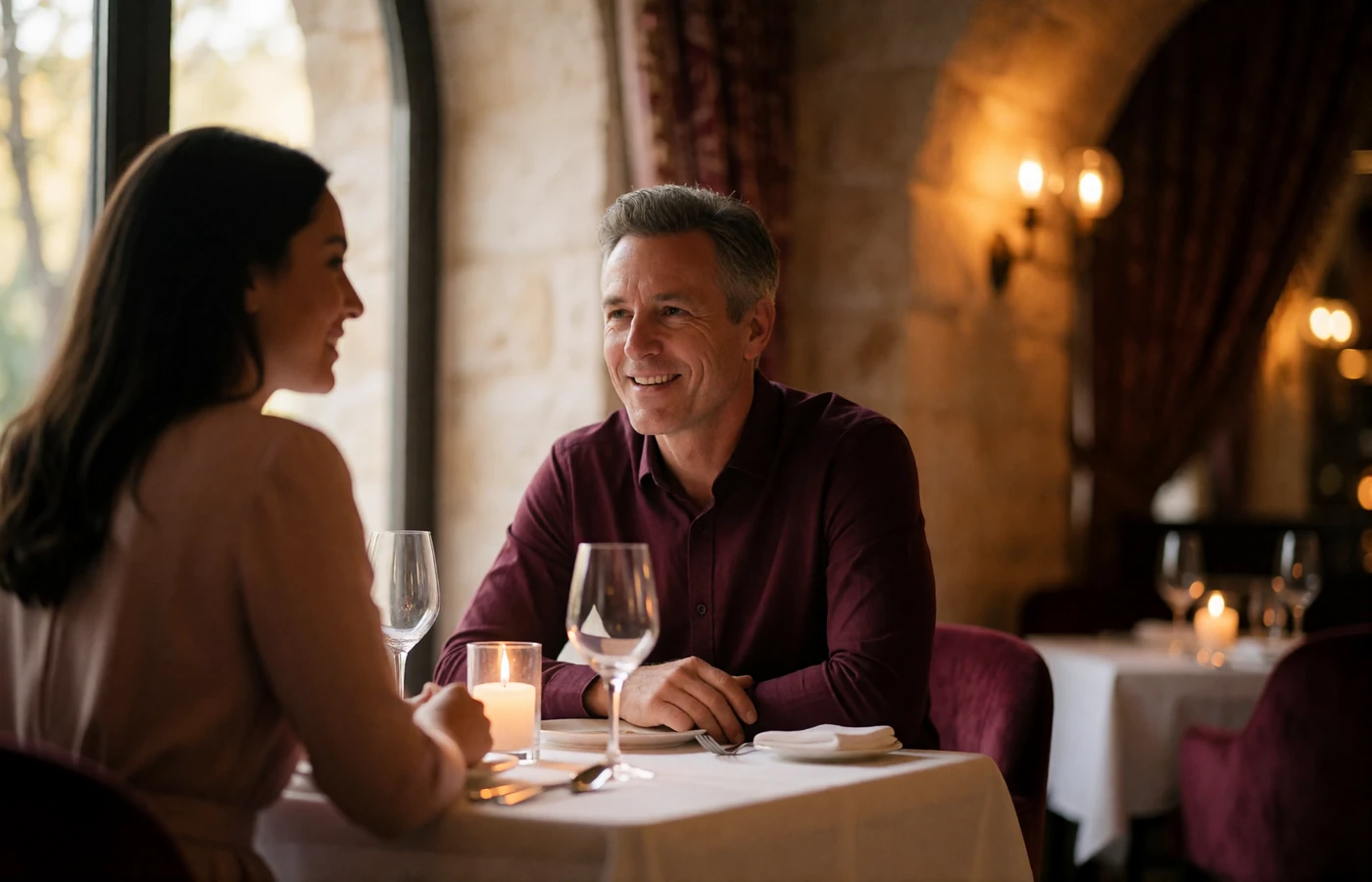 Jordanian woman and a Western man in conversation at a candlelit table in a fine-dining restaurant